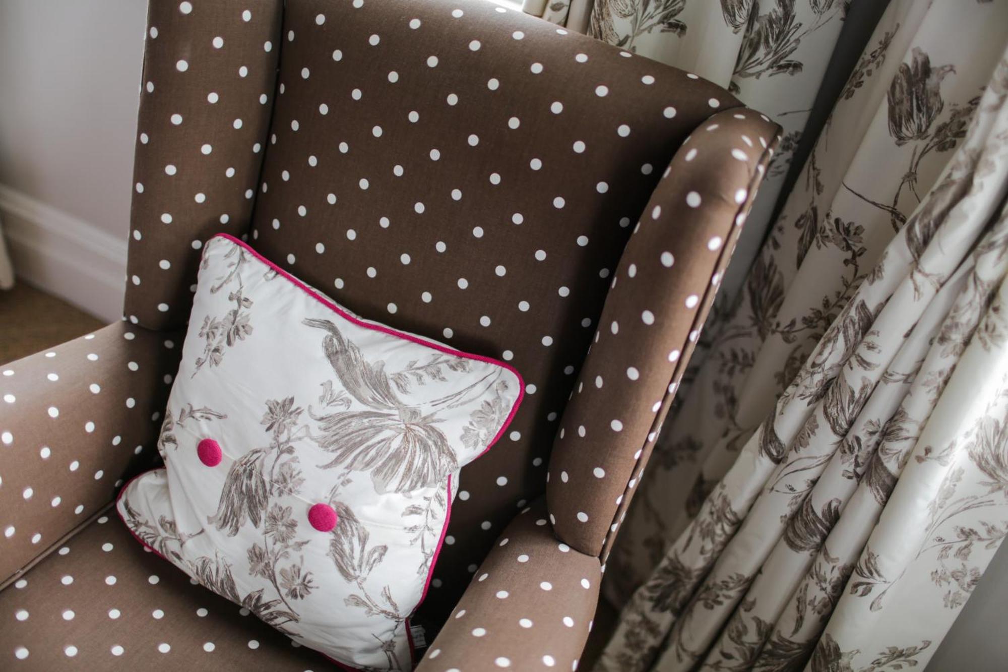Grays Boutique B&B Bath Room photo A chair upholstered in a polka dot fabric